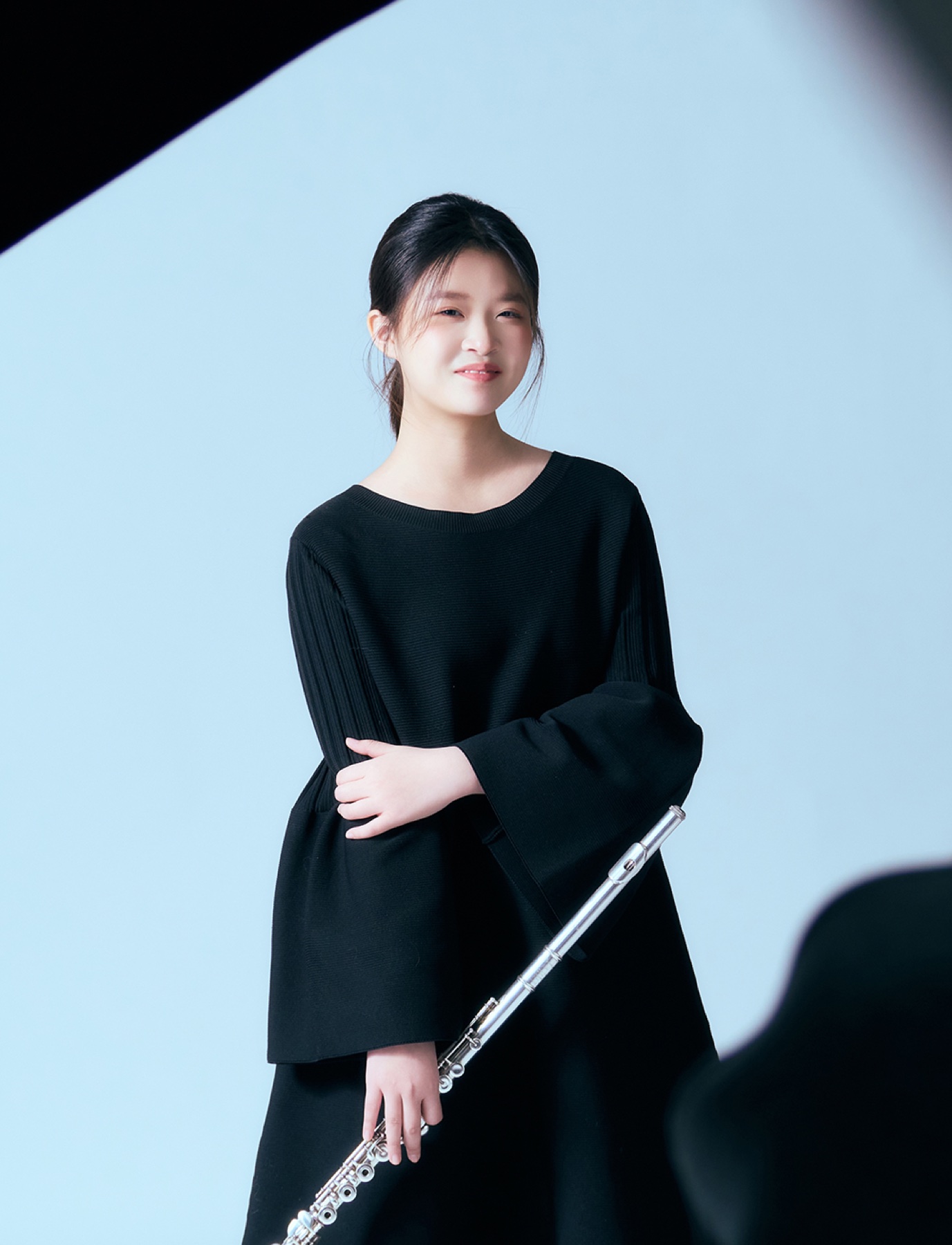 Schuwen Zheng standing with a flute